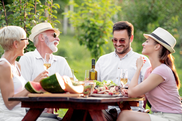 an older and younger couple sit at a table