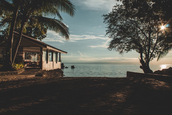 house on water with trees 